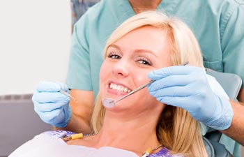 A smiling woman sitting in a dental chair